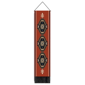 Detail of bohemian geometric wall tapestry with tribal diamond patterns and black tassels