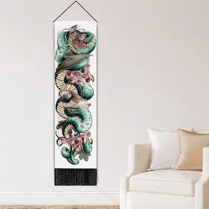 Artistic snake and flower tapestry with tassels hanging in a modern living room