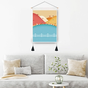 Modern landscape print wall tapestry with wooden rod and black tassels in a cozy living room