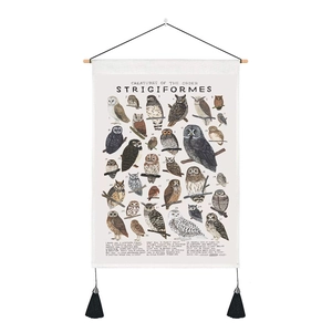 Detail of owl species educational canvas scroll with wooden bars and black tassels