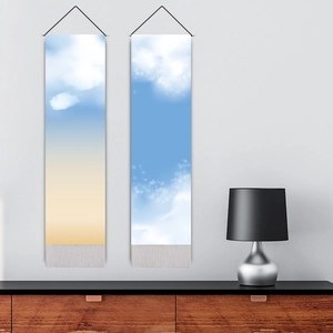 Modern wall hanging tapestry with blue sky and cloud print featuring grey bottom tassels