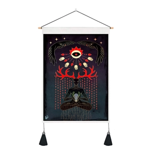 Detail view of gothic deer spirit tapestry with black tassels and wood hanging pole