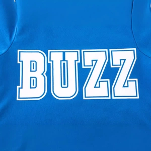 Blue boys long sleeve athletic T-shirt with bold BUZZ print and mesh texture