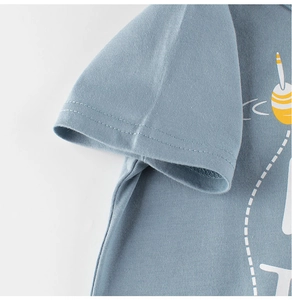 Detail of light blue cotton T-shirt featuring double-stitch sleeve hem and printed design