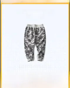 Detail of boys' camouflage joggers with elastic waistband and ribbed cuffs