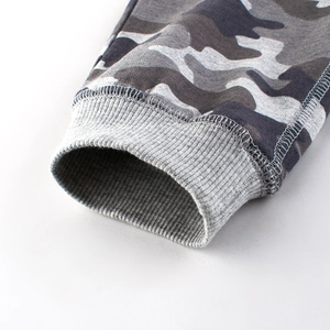 Close-up of boys' camo joggers featuring grey elastic ribbed cuffs and premium stitching
