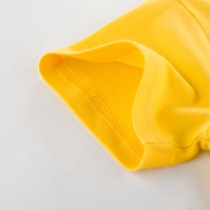 Detail of high-quality stitching on sleeve cuff of a bright yellow kids' cotton T-shirt