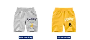 Detail of grey and yellow cotton sports shorts for boys featuring elastic waistband and prints