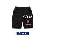 Detail of black cotton kids gym shorts with elastic waist and printed number five