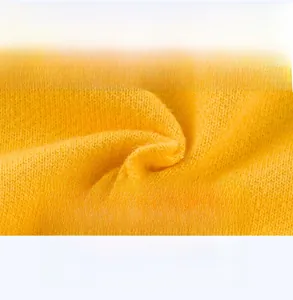 Close-up of soft yellow cotton knit fabric showing breathable texture for boys' shorts