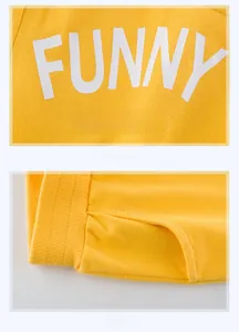 Close-up of yellow boys' shorts showing FUNNY print detail and fine stitching texture