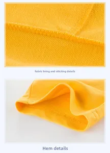 Detail view of cotton fabric texture and double-stitch sewing on yellow boys' shorts