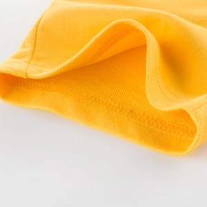 Detailed view of yellow cotton kids shorts featuring high-quality double-needle stitching