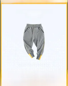 Detailed view of kids' gray joggers with yellow side stripes and ribbed color-block cuffs