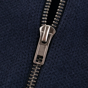 Close-up of deep blue knitted kids cardigan with a durable silver metal zipper detail
