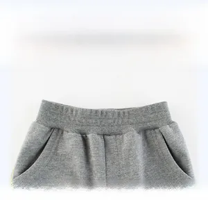 Detail view of the wide ribbed elastic waistband and side pockets on gray knit jogger pants