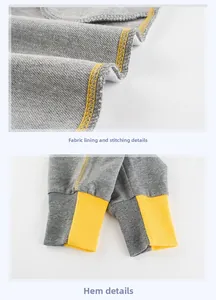 Detail of gray kids joggers showing soft loopback fabric and yellow ribbed cuffs