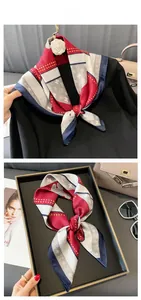 Detail of elegant silk scarf with red, white and blue geometric patterns on a black coat
