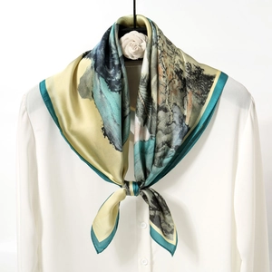 Elegant Chinese ink wash floral silk scarf with green borders on a white blouse