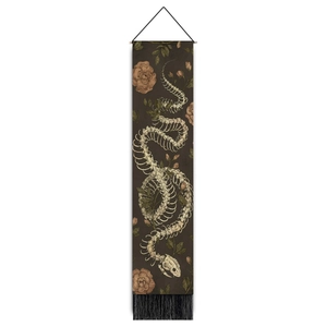Detail of gothic snake skeleton tapestry with vintage floral patterns and black tassels