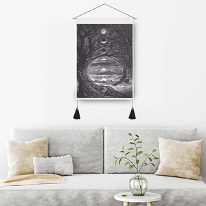 Monochrome tarot style tapestry with wooden hanger and black tassels on white wall