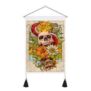 Detail of gothic tarot tapestry featuring a skull and snake with wood scroll and tassels