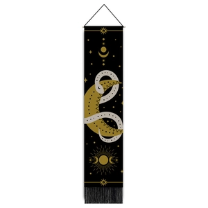 Detail of snake tapestry with celestial moon and sun patterns and black tassels