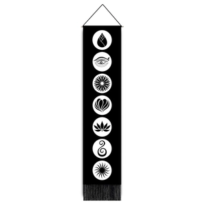 Vertical black yoga tapestry detail featuring seven white chakra symbols and bottom tassels