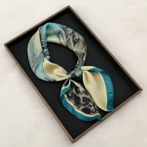 Detailed view of floral silk scarf featuring landscape ink painting and dark green borders