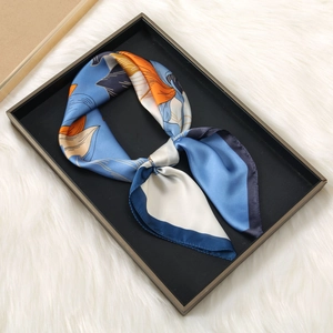 Elegant 70cm silk square scarf featuring artistic blue and orange prints on satin fabric