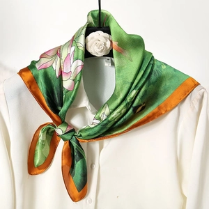 Floral print 70cm silk-like scarf with green lotus pattern tied on white shirt