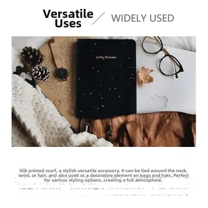 Flat lay of vintage floral silk scarf with laptop, glasses, and autumn leaves accessories