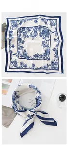 Detail of vintage floral silk scarf featuring navy botanical patterns and bee illustrations