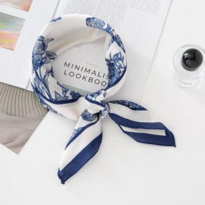 Elegant blue floral silk scarf with striped borders on minimalist background