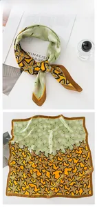Detail of silk square scarf featuring maple leaf print and contrast color blocking