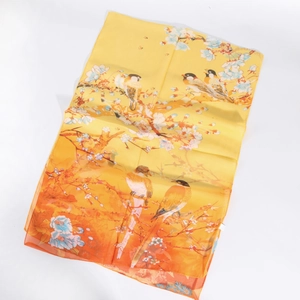 Macro detail of bird and floral print on lightweight orange gradient chiffon scarf
