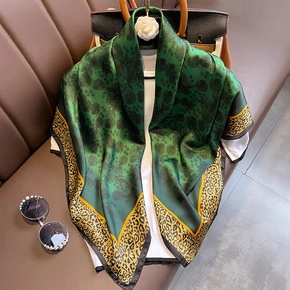 Elegant emerald green faux silk scarf with golden leopard print border for women
