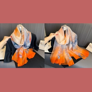 Elegant floral print silk shawl with orange and navy ink patterns for sun protection