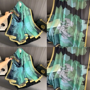 Lightweight black scarf with green floral print and yellow hem, oversized fashion wrap