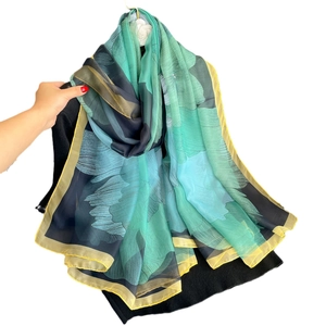 Floral print oversized sun protection shawl in gradient teal with yellow hem borders