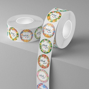 Roll of floral thank you stickers with botanical designs for gift packaging and wedding favors