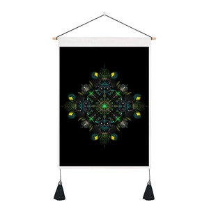 Detail of bohemian mandala wall hanging with black tassels and a wooden hanging rod