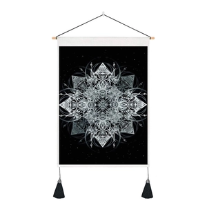 Close-up of bohemian mandala tapestry with wooden rod and black tassels