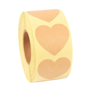 Macro detail of heart-shaped brown kraft paper labels on a roll for gift wrapping