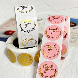 Roll of round kraft paper thank you stickers with gold foil stamping and wheat ears