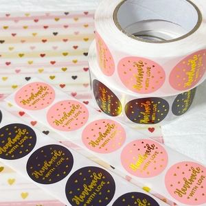 Roll of pink and black handmade with love stickers with gold foil for gift packaging