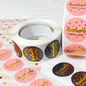 Pink and black round stickers with gold foil Handmade WITH LOVE text on a roll