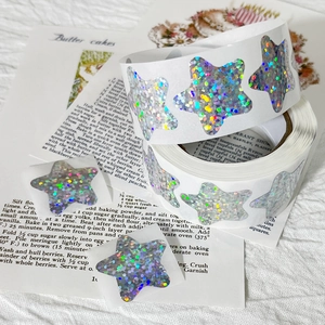 Close-up of holographic star-shaped sticker roll with colorful laser finish for decoration
