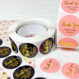 Gold foil pink and black Thank You stickers in rolls for wedding and gift packaging