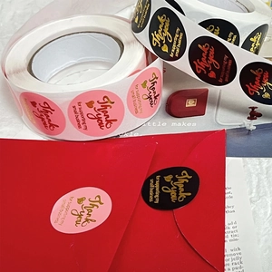 Roll of pink and black round Thank You stickers with gold foil for wedding envelopes